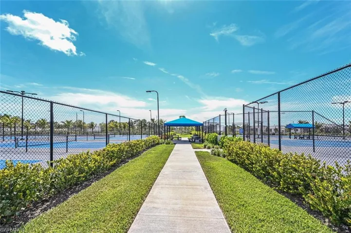 View of property's community featuring a tennis court