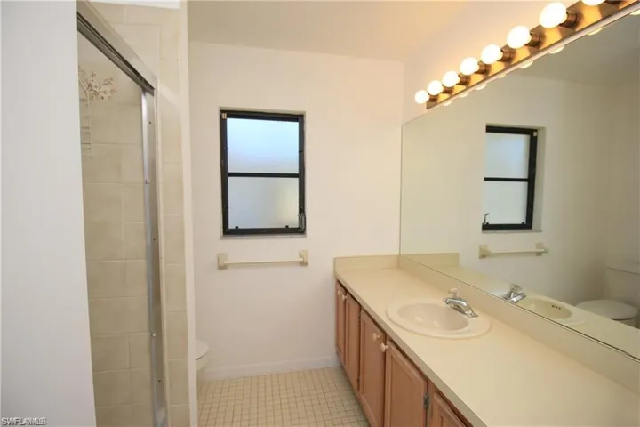 Bathroom featuring tile flooring, oversized vanity, and toilet
