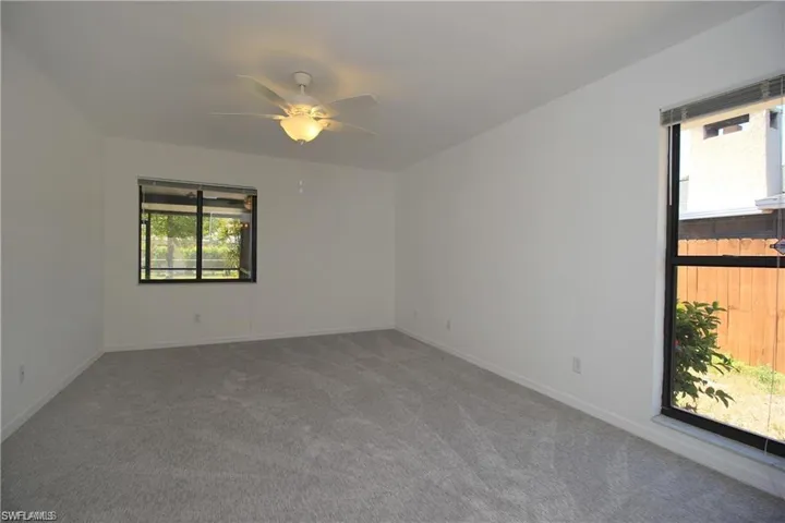 Carpeted spare room with ceiling fan
