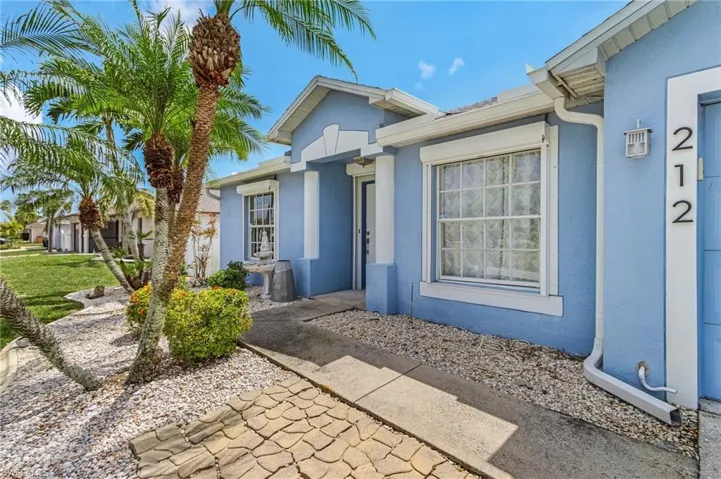 View of exterior entry featuring stucco siding