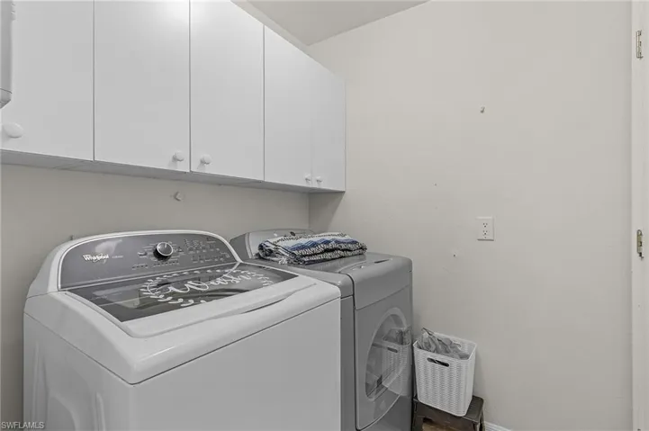 Clothes washing area with washing machine and dryer and cabinet space
