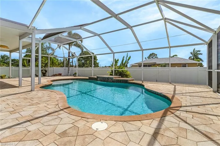 View of swimming pool with a patio area, a fenced in pool, a fenced backyard, and a lanai