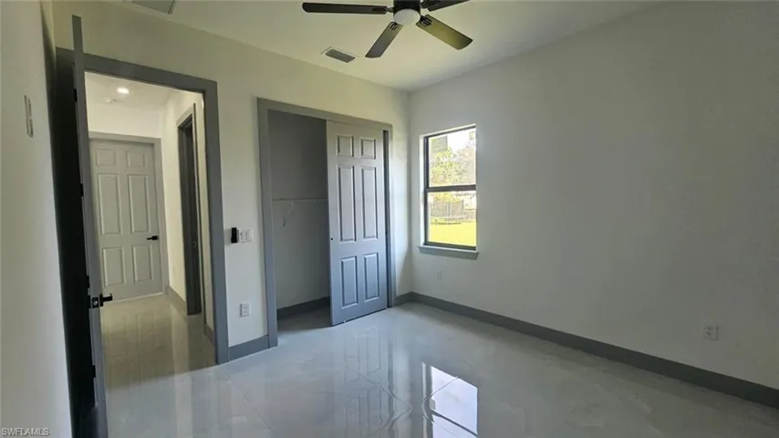 Unfurnished bedroom with a closet and ceiling fan