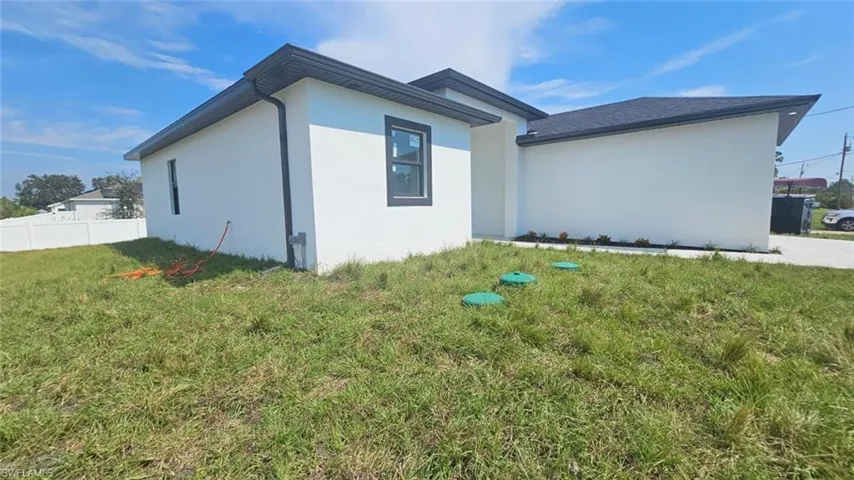View of property exterior with a lawn