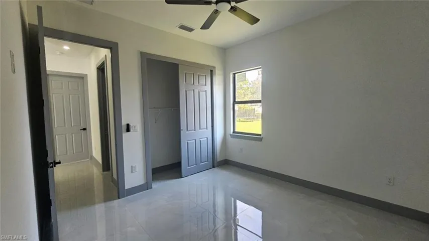 Unfurnished bedroom featuring a closet and ceiling fan