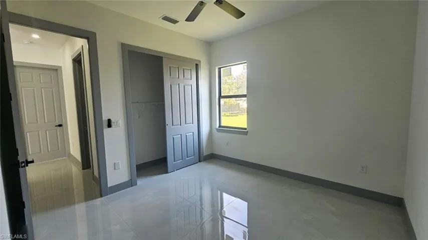 Unfurnished bedroom with a closet and ceiling fan