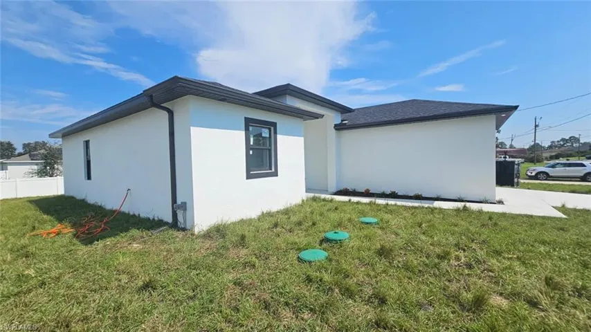 View of side of home featuring a yard