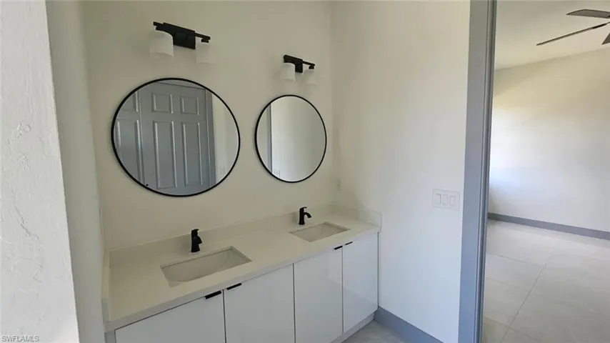 Bathroom featuring vanity and ceiling fan