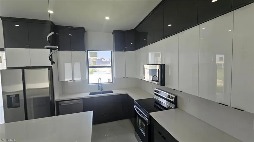 Kitchen with appliances with stainless steel finishes and sink