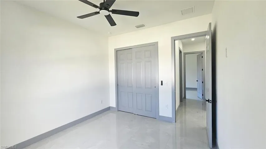 Unfurnished bedroom featuring a closet and ceiling fan