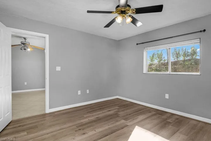 Empty room featuring a ceiling fan and light wood-style floors