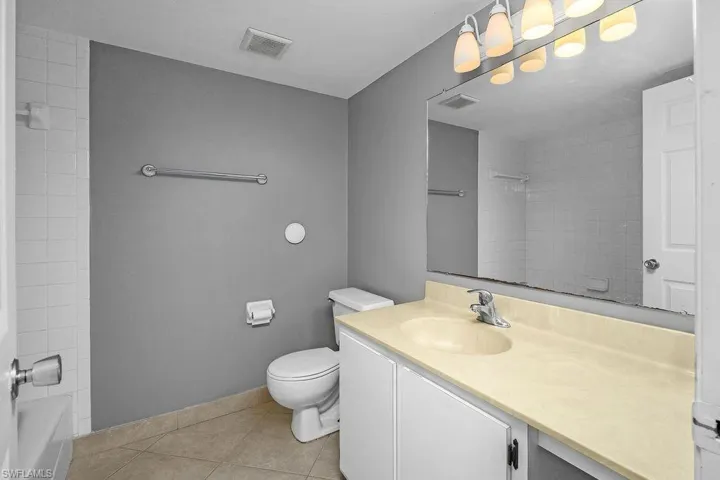 Full bathroom featuring vanity, light tile patterned floors, and bathtub / shower combination