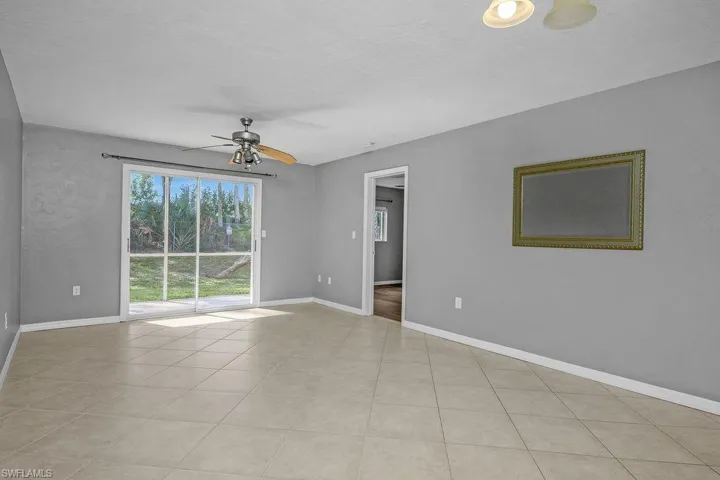 Spare room featuring ceiling fan and light tile patterned floors