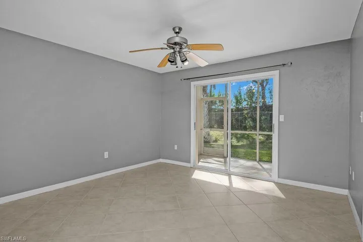 Unfurnished room featuring ceiling fan and light tile patterned floors