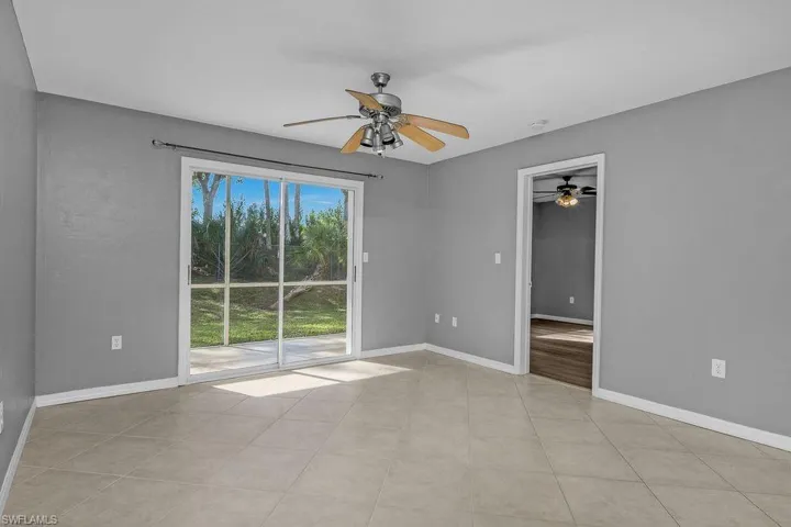 Empty room with ceiling fan and baseboards