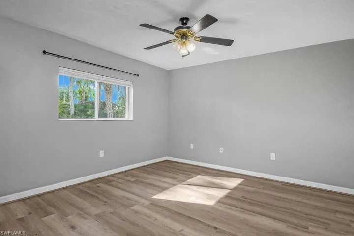 Spare room featuring light wood-type flooring and a ceiling fan