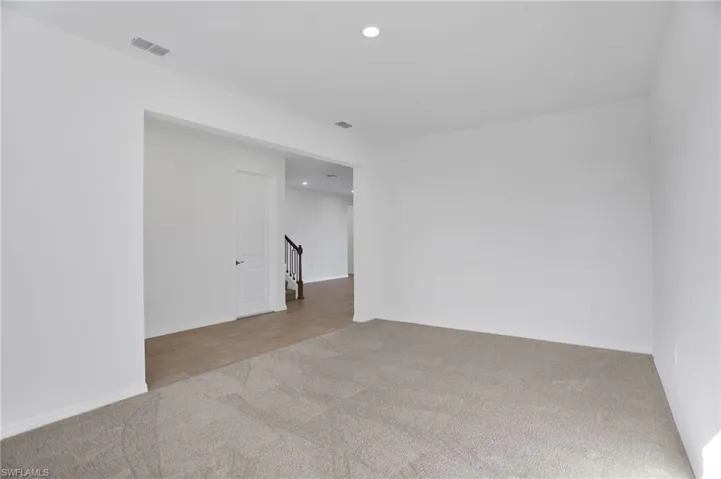 Empty room featuring light colored carpet and recessed lighting