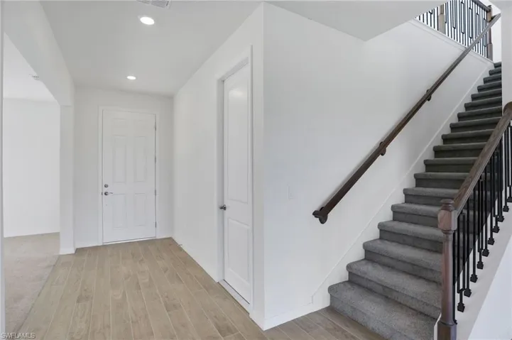 Foyer featuring light wood-style floors and recessed lighting