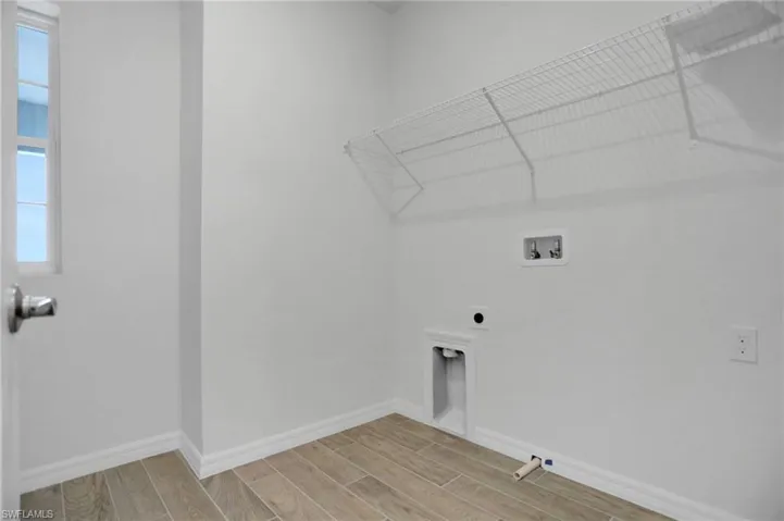 Laundry room with wood tiled floors, washer hookup, and electric dryer hookup