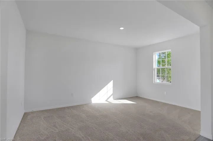 Empty room featuring light carpet and recessed lighting