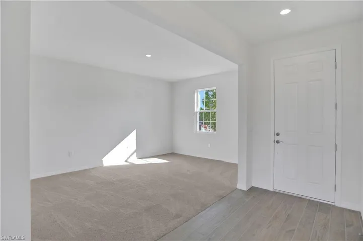 Entrance foyer with light wood-type flooring and recessed lighting