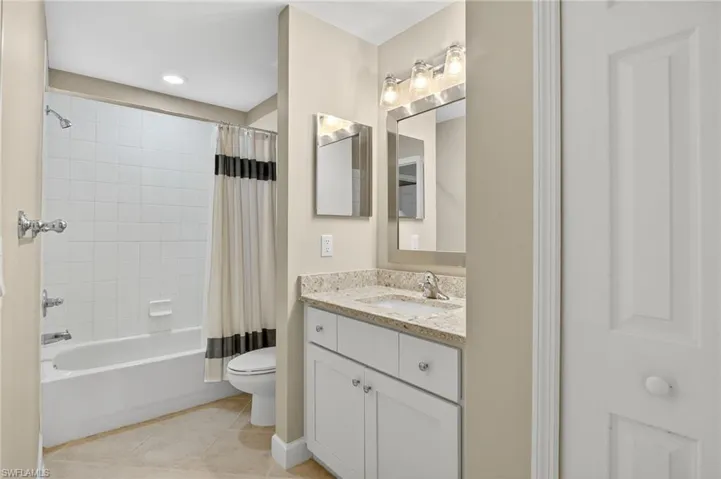 Full bathroom featuring shower / tub combo, vanity, light tile patterned floors, and recessed lighting