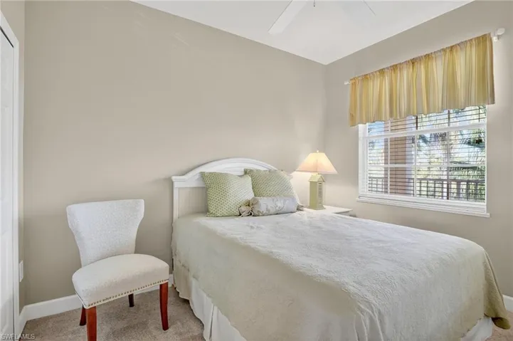 Bedroom featuring a ceiling fan and light carpet