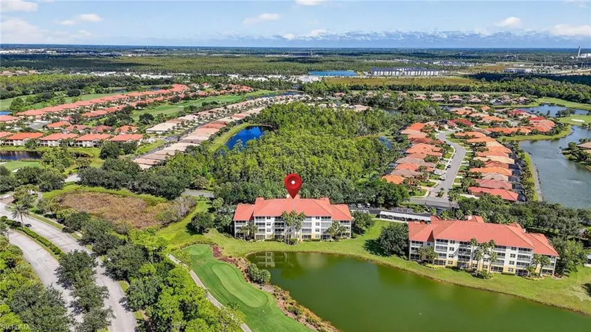 Aerial view of residential area with a large body of water and a local golf course