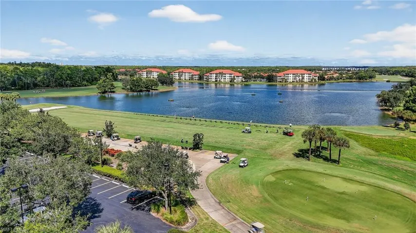 Aerial view of a golf course and a nearby body of water