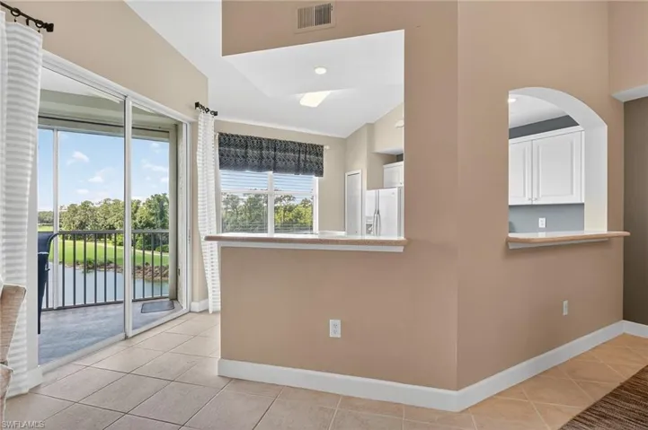 Kitchen with light tile patterned floors and baseboards