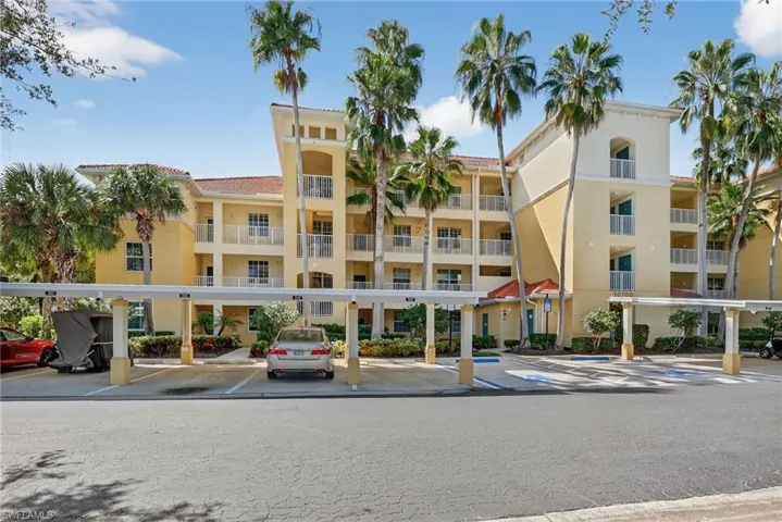 View of apartment building / complex with covered parking