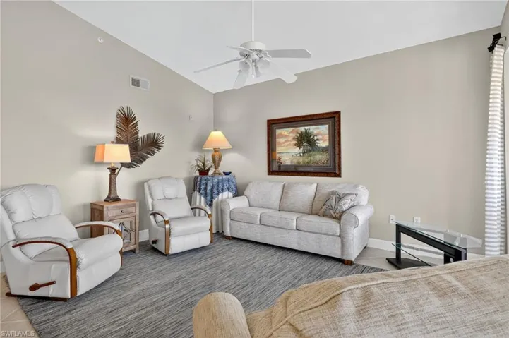 Tiled living room featuring baseboards and ceiling fan
