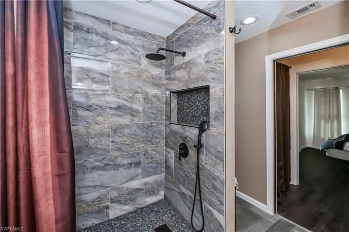 Bathroom featuring hardwood / wood-style flooring and walk in shower