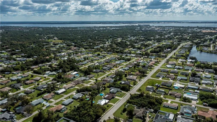 Birds eye view of property with a water view