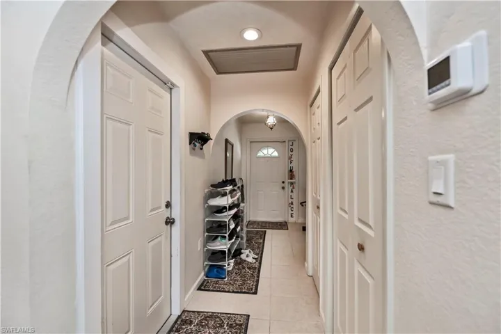 Doorway with light tile patterned flooring