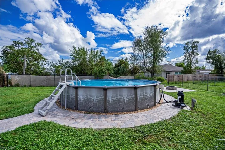View of pool with a yard