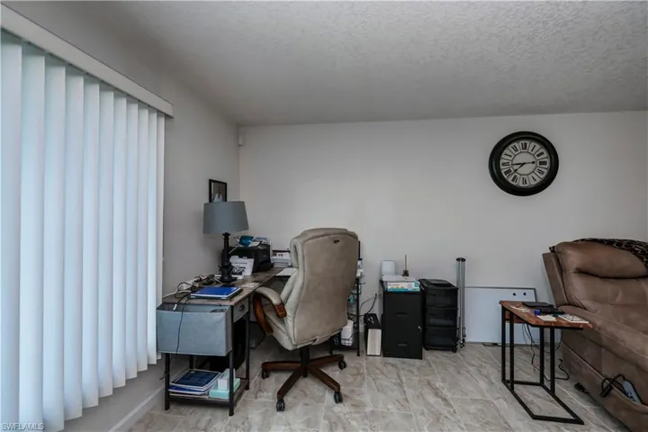 Home office featuring a textured ceiling