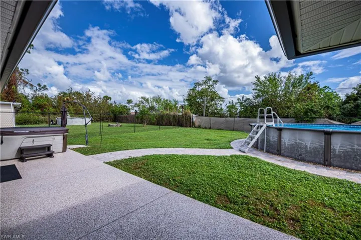 View of yard with a swimming pool with hot tub and a patio