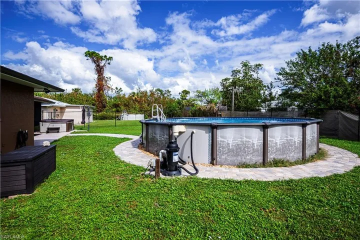 View of yard with a pool with hot tub