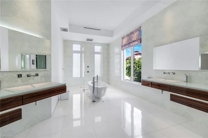 Spa-like bathroom with Allmilmo cabinetry, Bisazza mosaic tile, Dornbracht fixtures, and Thassos marble floors.