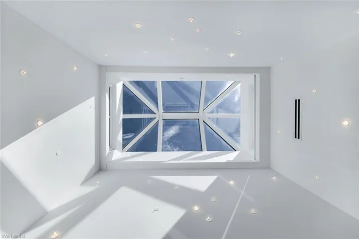Architectural skylight with custom recessed lighting, flooding the space with natural light.
