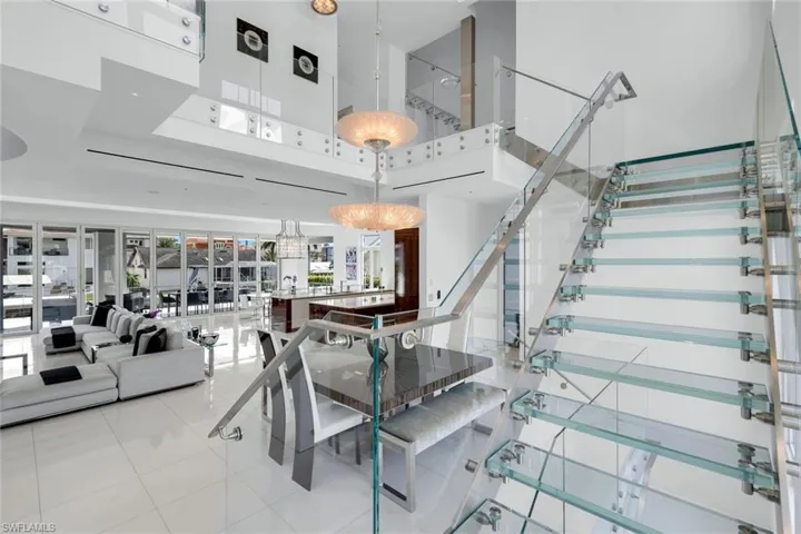 Custom glass staircase with stainless-steel accents, showcasing sleek modern craftsmanship