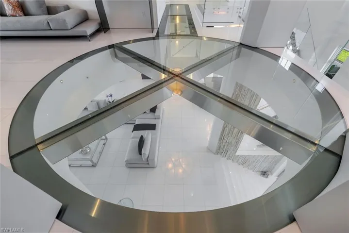Custom glass and stainless-steel floor with precision engineering and contemporary architectural design.