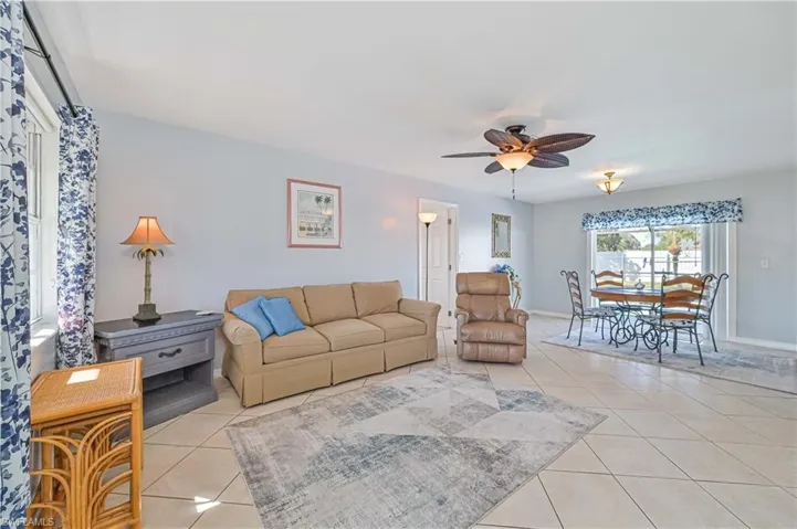 Tiled living room featuring ceiling fan