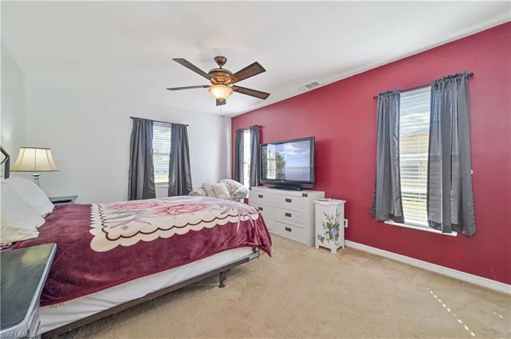 Bedroom featuring light colored carpet and ceiling fan