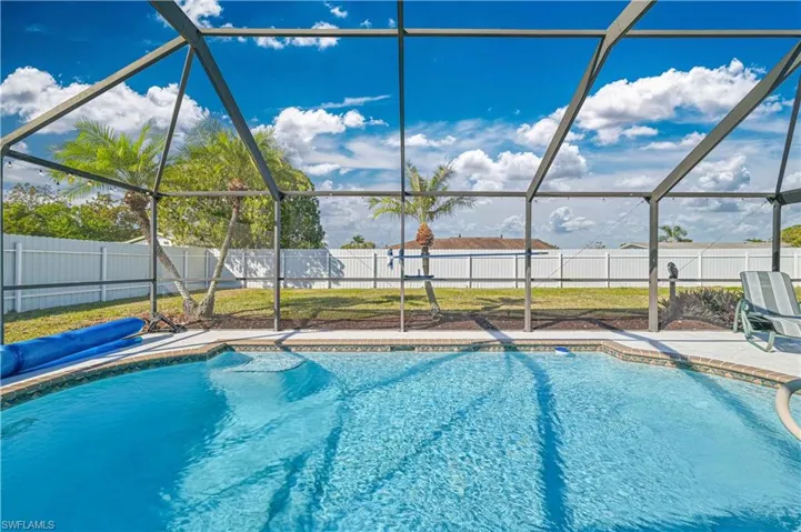 View of swimming pool with a lanai