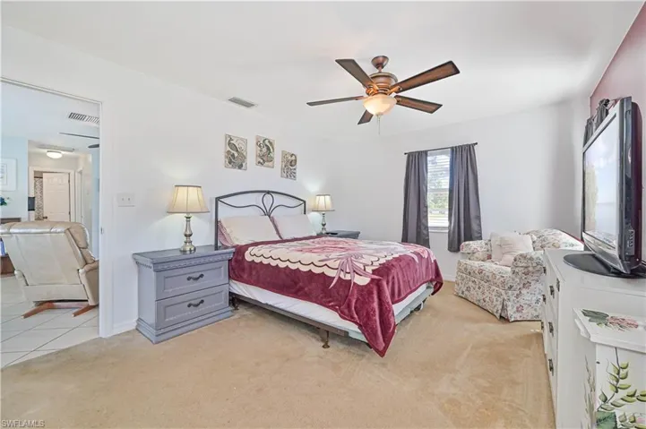 Carpeted bedroom with ceiling fan
