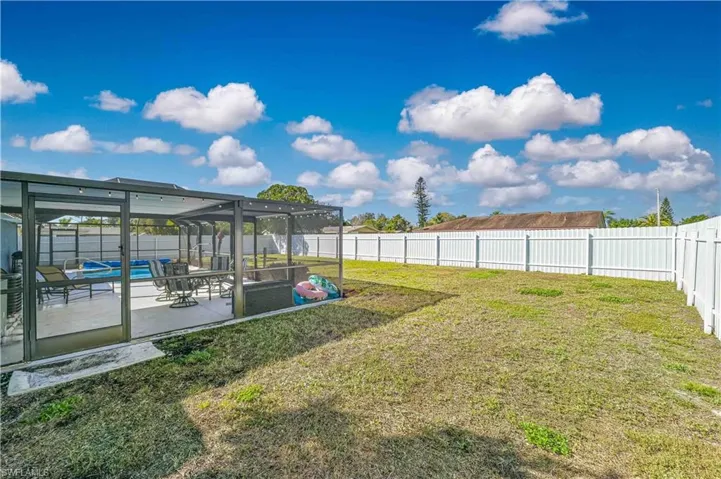 View of yard with a lanai, a swimming pool, and a patio area
