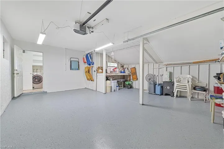 Garage with washer / clothes dryer and a garage door opener