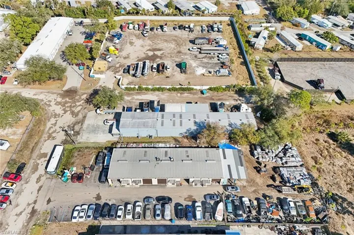 Aerial view of property and surrounding area with industrial structures